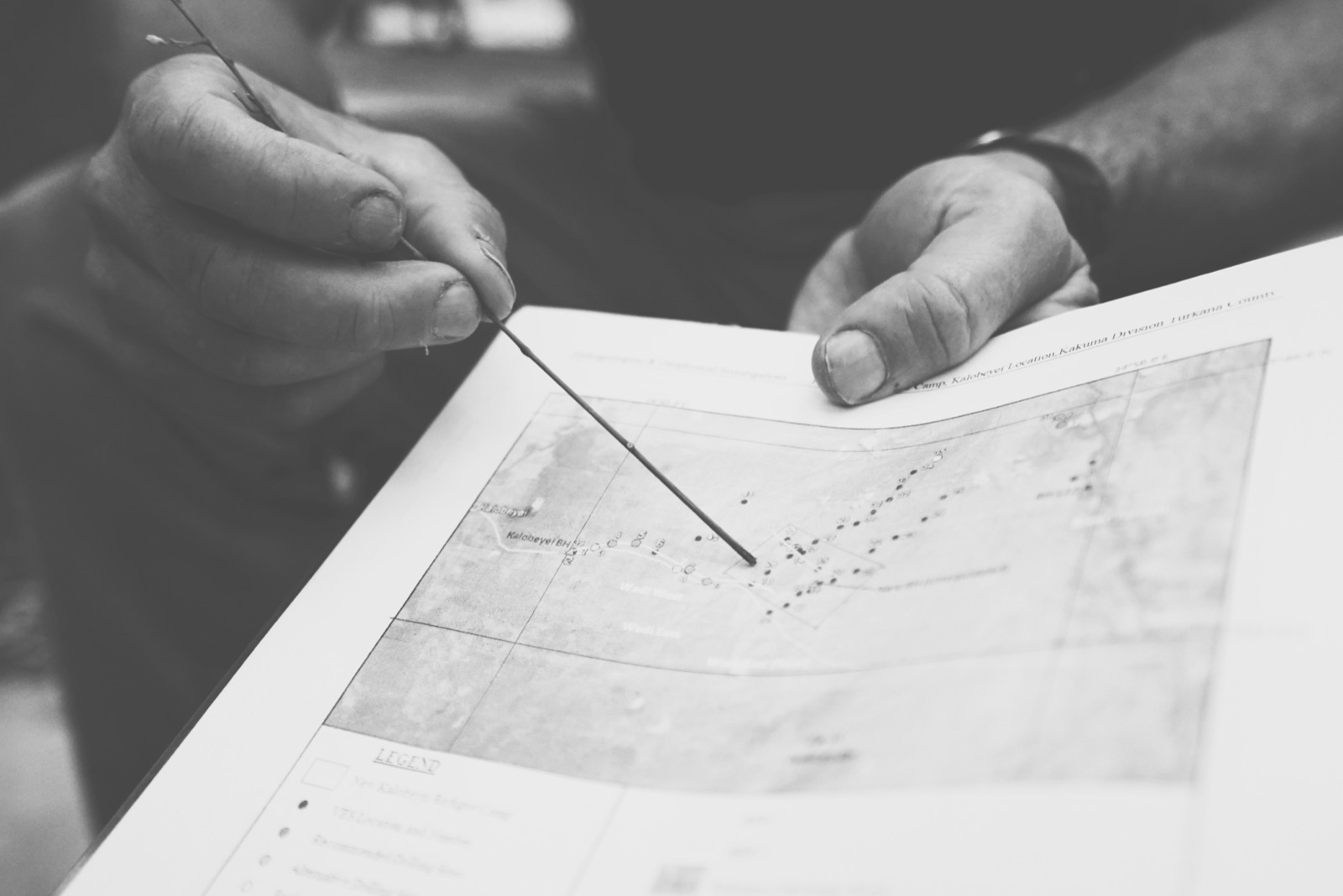 Hands pointing to a map of Kakuma Division, Turkana County