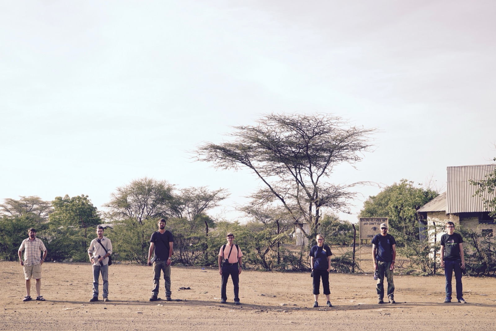 The Finding Water crew standing in a line on dusty ground