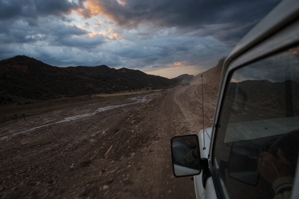 A vehicle ahead on a mountain road, seen from a moving car in Tajikistan